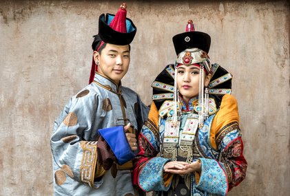 mongolian couple in traditional outfit near old Temple in Ulaanbaatar in traditional outfit near old Temple in Ulaanbaatar