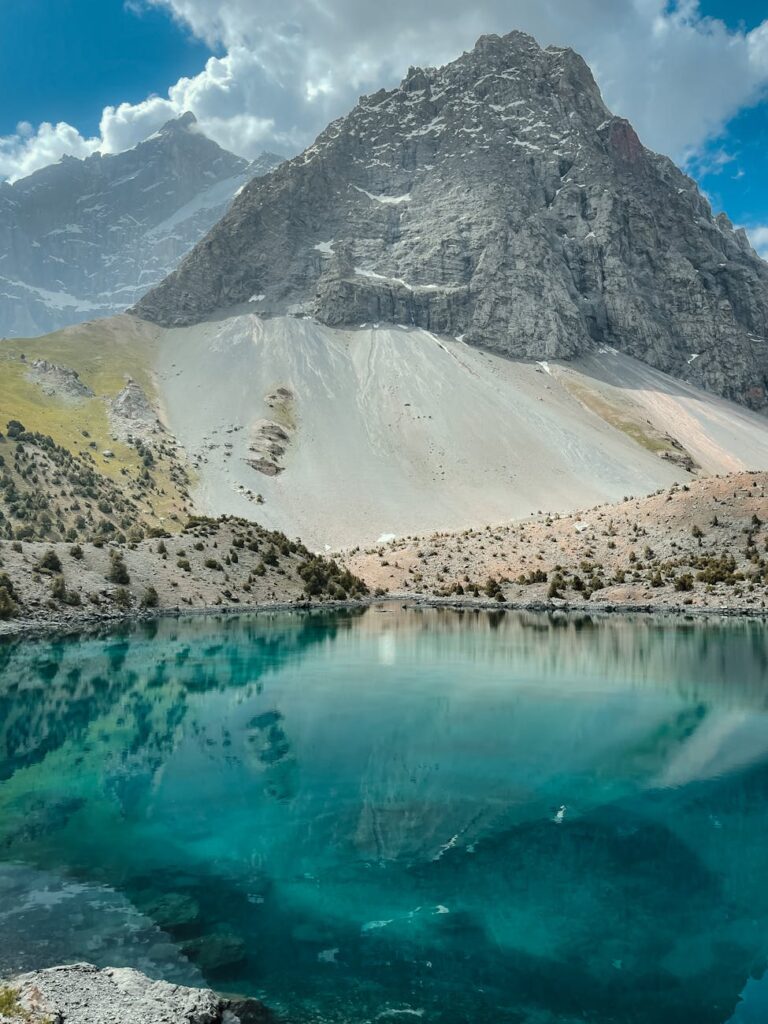 mountains and hills towering over a lake