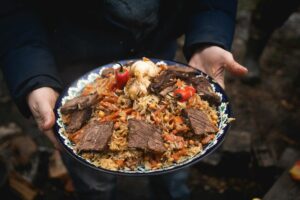 Uzbekistan Cuisine close up of holding delicious food on a plate