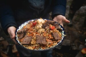 holding a plate with delicious food