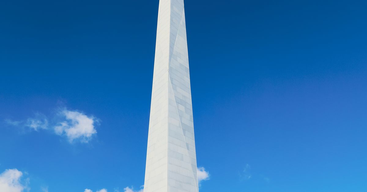 A tall monument in Astana, Kazakhstan against a bright blue sky