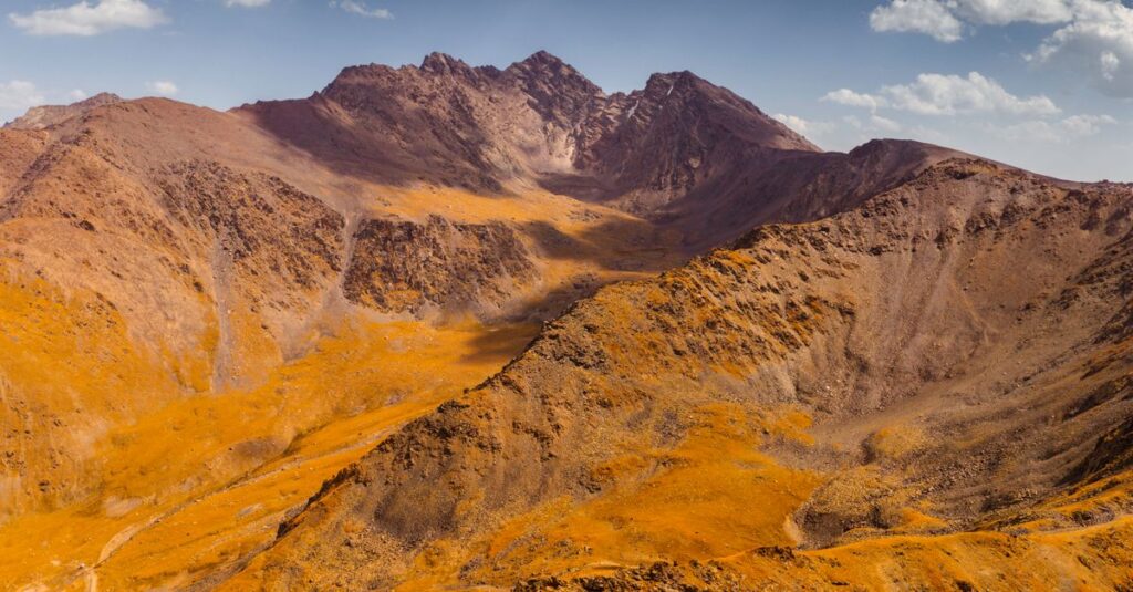 Aerial view of a Kyrgyzstan mountain range in vivid autumn colors