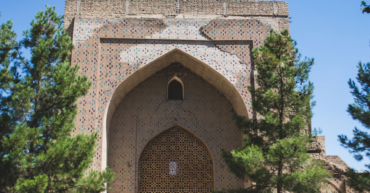 Facade and dome of the Bibi-Khanym Mosque in Samarkand under a clear blue sky