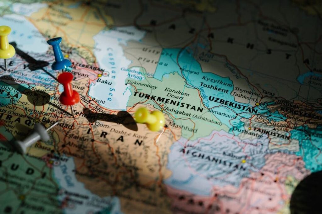 Pushpins marking destinations on a detailed map of Central Asia