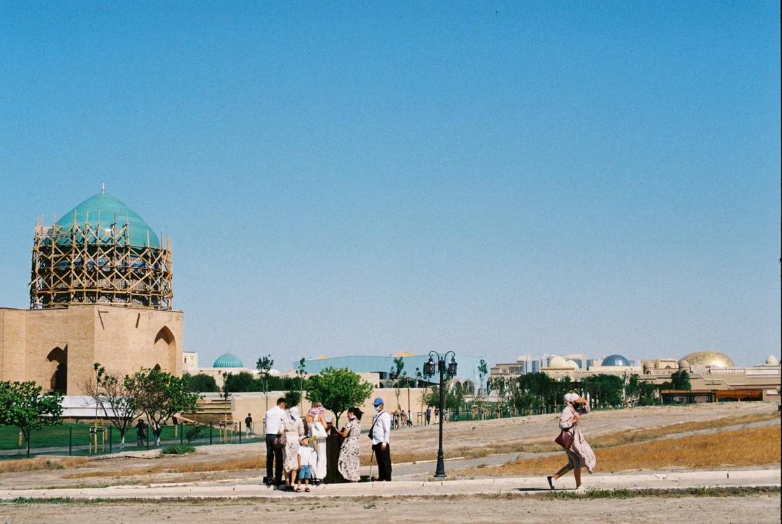 Family visiting historical landmarks in Turkistan on a sunny day