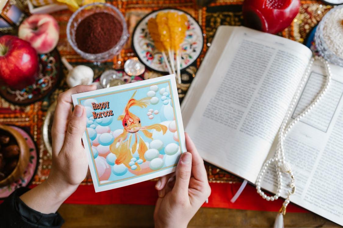 Vibrant Haft Seen display with a Happy Norooz card.