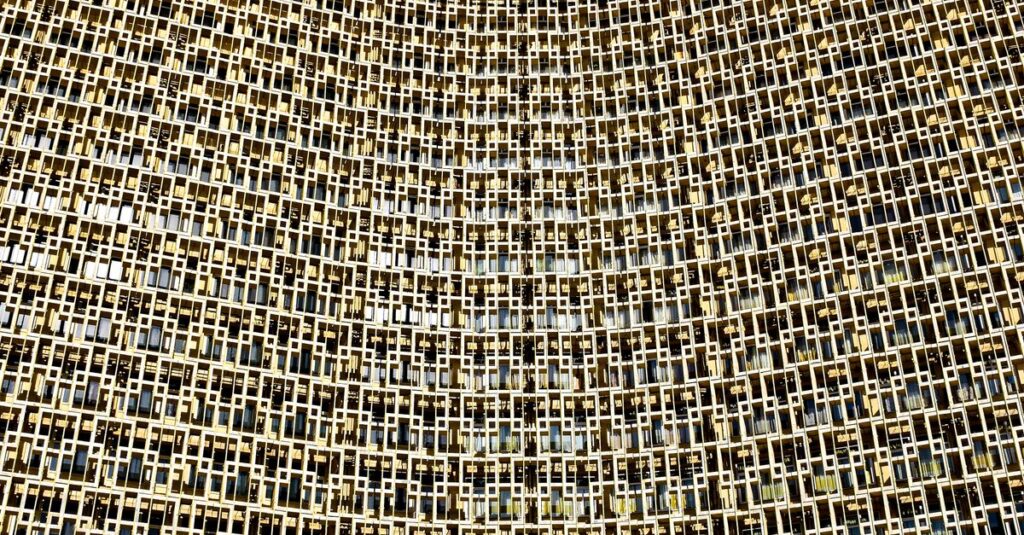 The impressive facade of Hotel Uzbekistan in Tashkent against a clear blue sky
