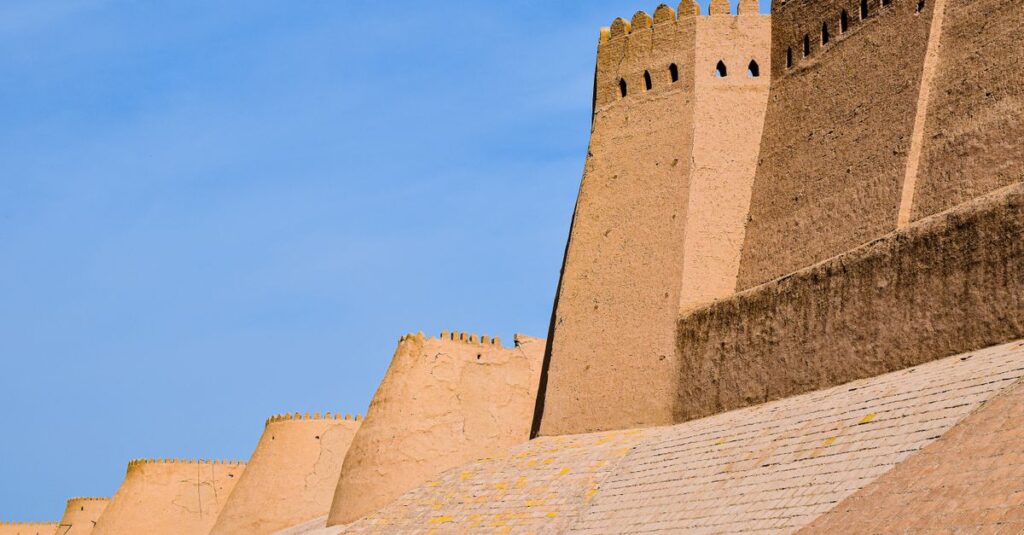 Historic walls of Ichan Kala in Khiva, Uzbekistan under a clear blue sky