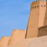 Historic walls of Ichan Kala in Khiva, Uzbekistan under a clear blue sky