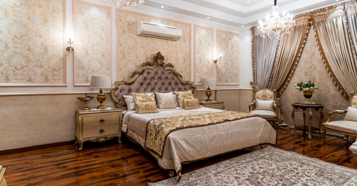 An elegant, ornately decorated luxury hotel suite with chandeliers