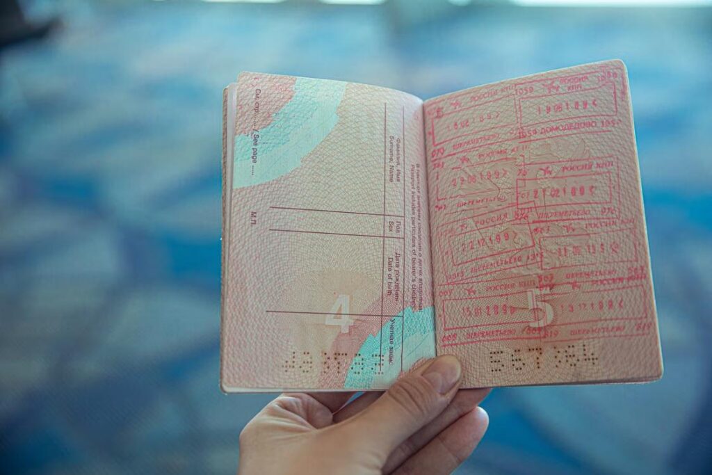 Open passport displaying various international travel stamps