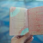 Open passport displaying various international travel stamps
