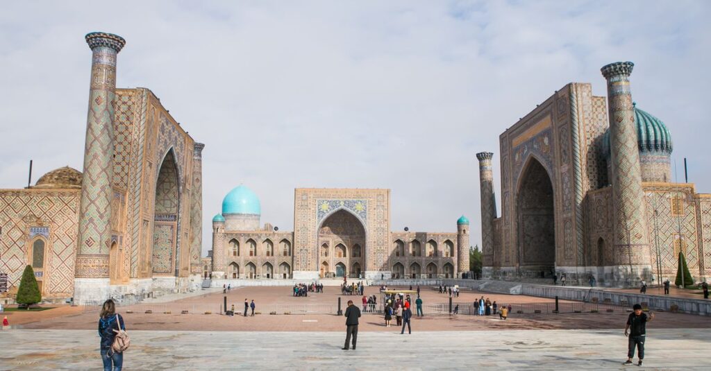 Tourists walking through Registan Square in Samarkand, Uzbekistan