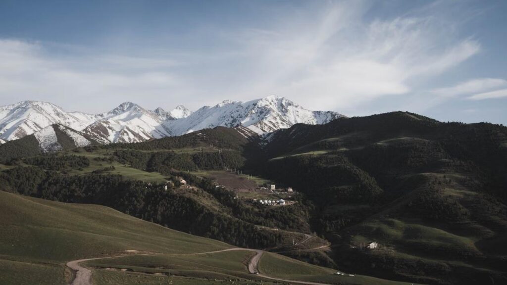 Snow-capped mountains and traditional yurts in Kyrgyzstan