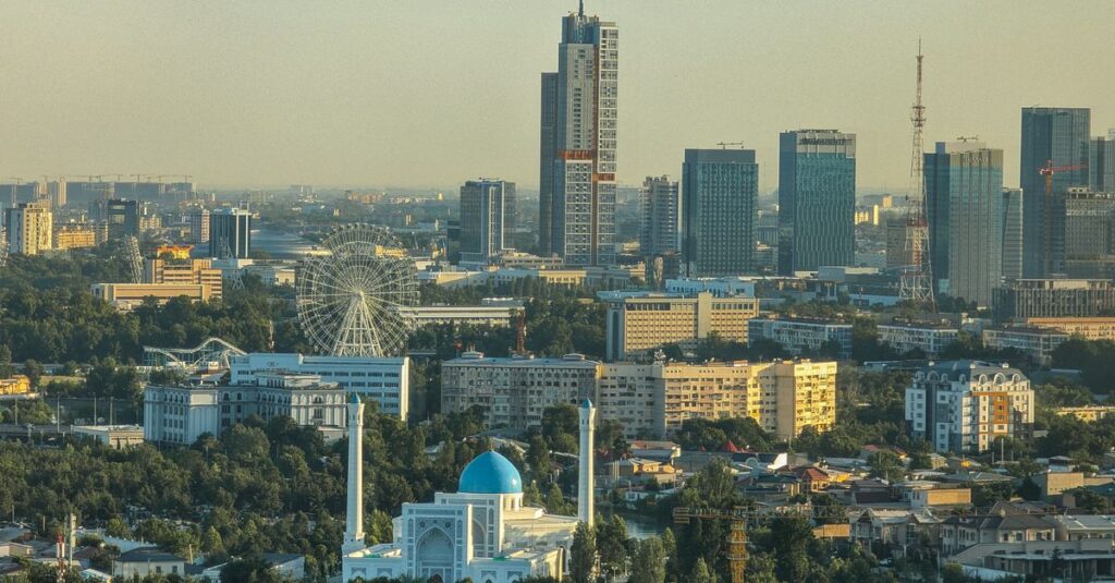 Aerial daytime view of Tashkent skyline featuring modern buildings and historic architecture