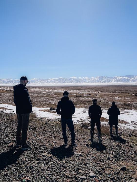Tourists sightseeing in a snowy desert landscape of Kazakhstan