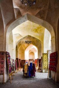Traditional handwoven carpets displayed at a bazaar in Bukhara, Uzbekistan