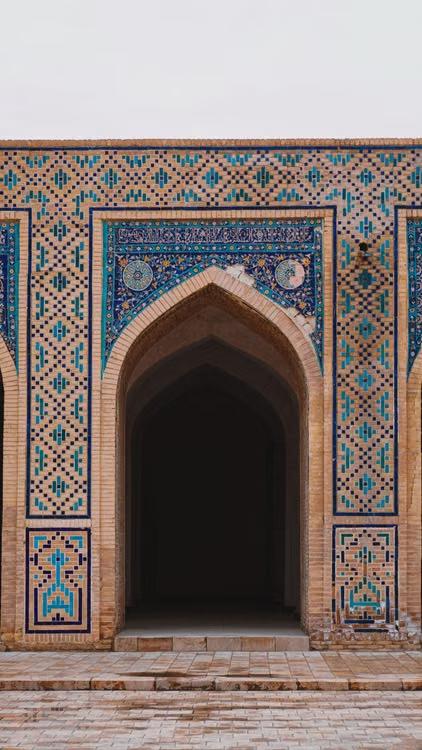 Intricate mosaic tile patterns on a historic Bukhara building