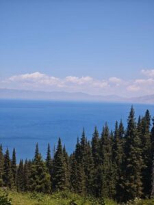 Beautiful view of Lake Issyk-Kul with Tian Shan mountains in the background under a clear blue sky
