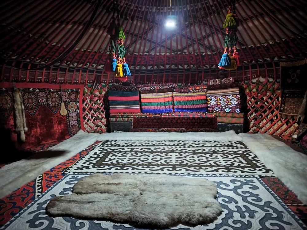 Interior of a traditional yurt in Kyrgyzstan decorated with patterned textiles