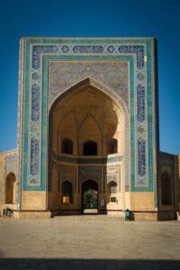 Facade of the Mir-i-Arab Madrasa in Bukhara, Uzbekistan under a clear sky
