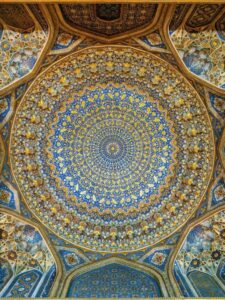 Stunning ceiling inside the Tilya-Kori Madrasa in Samarkand showing intricate patterns
