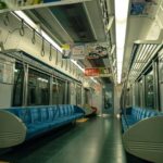 Empty train interior with colorful overhead advertisements in an urban transit setting