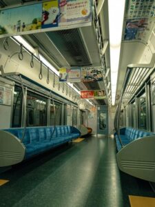 Empty train interior with colorful overhead advertisements in an urban transit setting