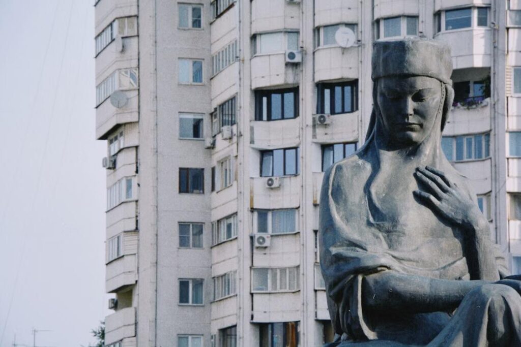 Large statue in front of a Soviet-era apartment building in Almaty, Kazakhstan.