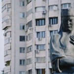 Large statue in front of a Soviet-era apartment building in Almaty, Kazakhstan.