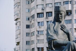Large statue in front of a Soviet-era apartment building in Almaty, Kazakhstan.