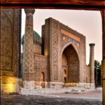 Registan Square in Samarkand, Uzbekistan, with ornate blue tilework, domes, and decorated arches.